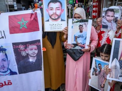 Families of young missing Moroccan migrants carry pictures of their missing relatives as they demonstrate in front of the Ministry of Foreign Affairs in Rabat on May 4, 2022. (Photo by FADEL SENNA / AFP)